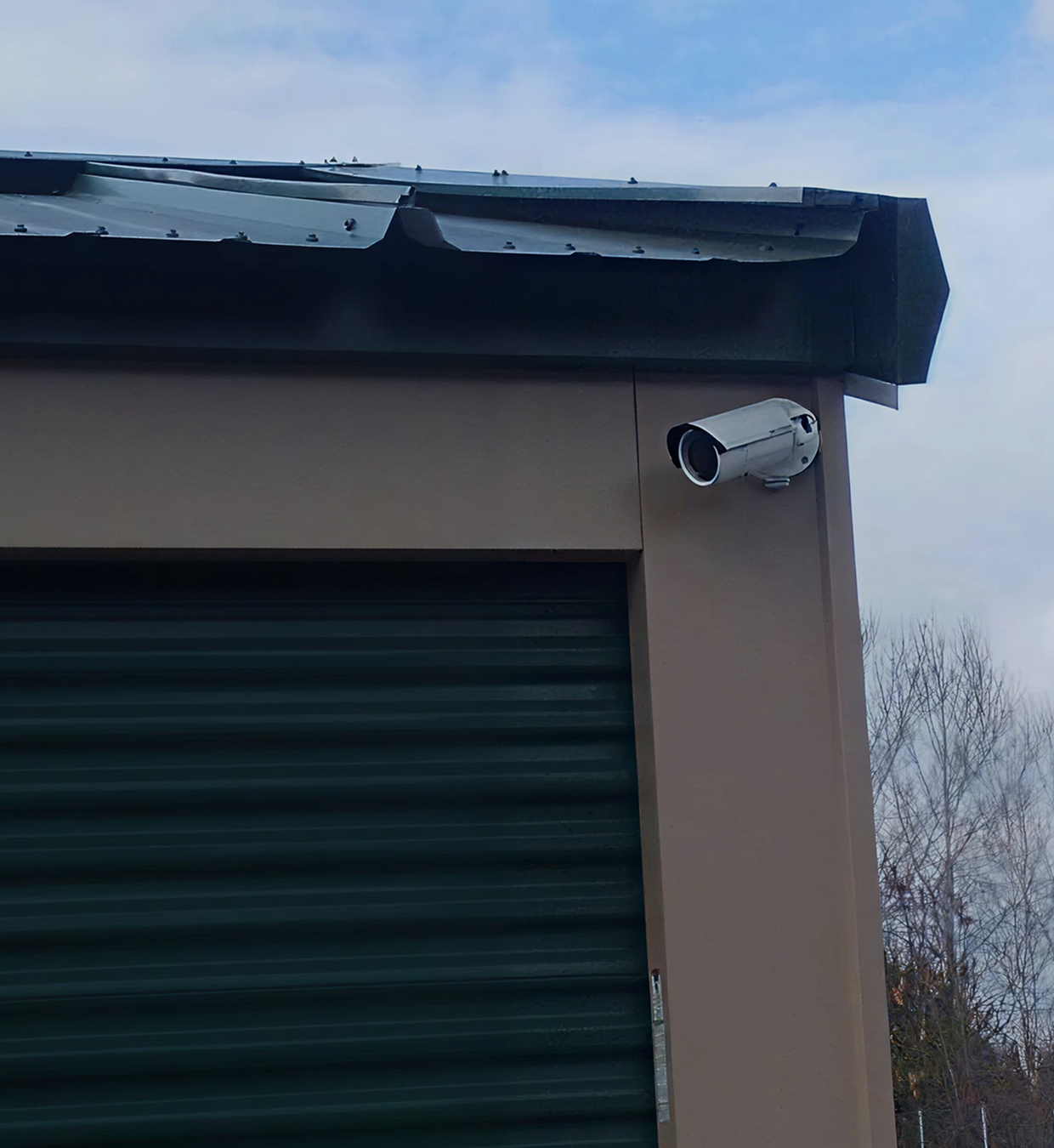 Security camera mounted on building corner.