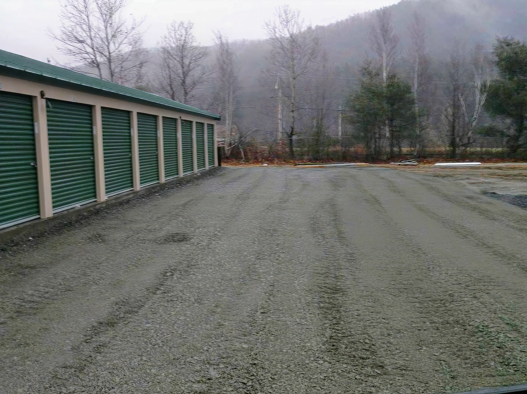 Storage units beside gravel-covered ground.